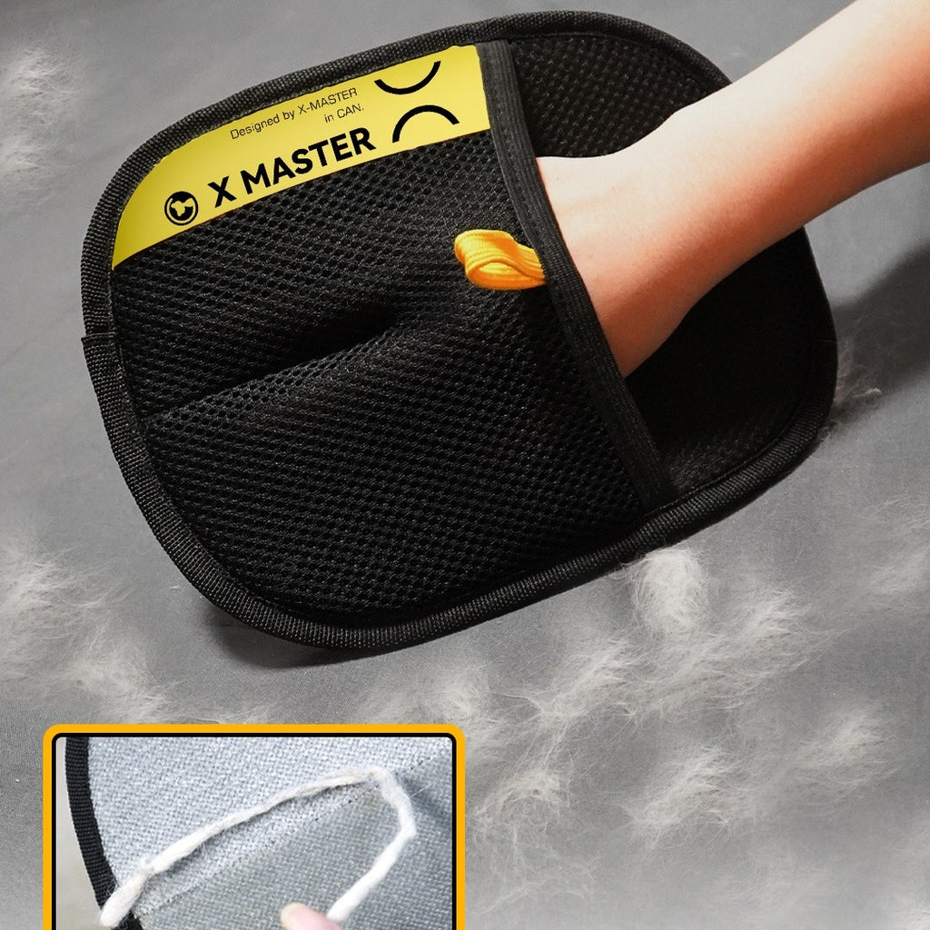 Black cleaning mitt with yellow X Master label on a gray background