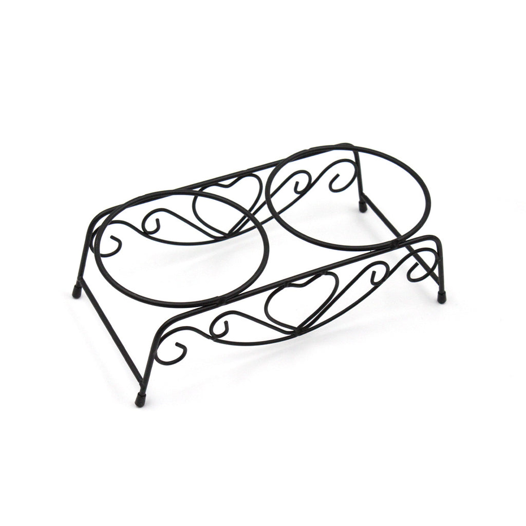 Decorative black metal fruit basket with curved handles on a white background
